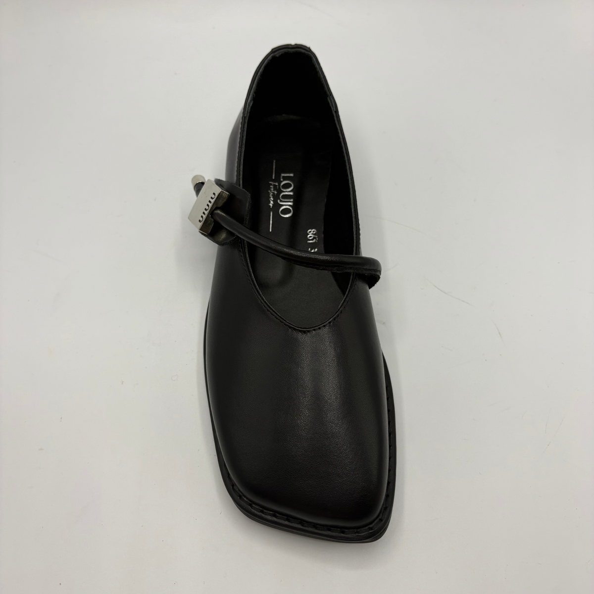 Top view of a black leather ballet flat shoe with silver accents
