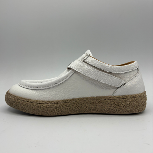 Left facing view of a white leather shoe with a rubber outsole and a buckle closure