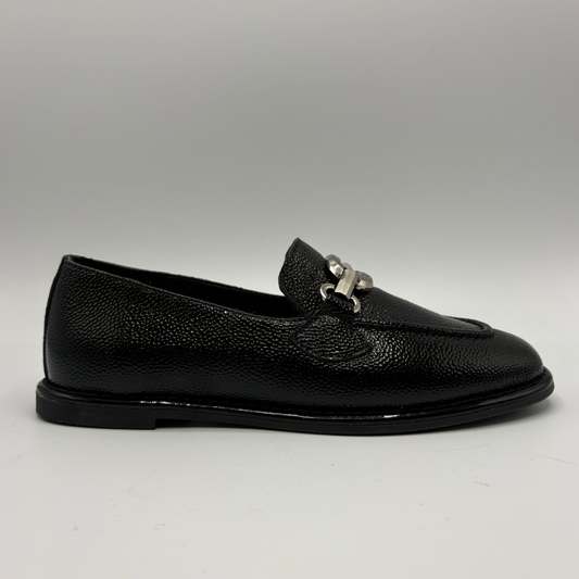 Right facing view of a black pebbled leather loafer with a silver accent on the toe box