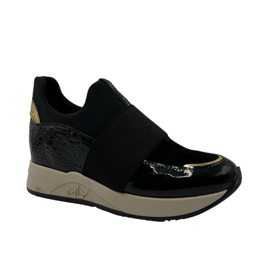 45 degree angled view of black hidden wedge sneakers with an elastic closure and beige outsole