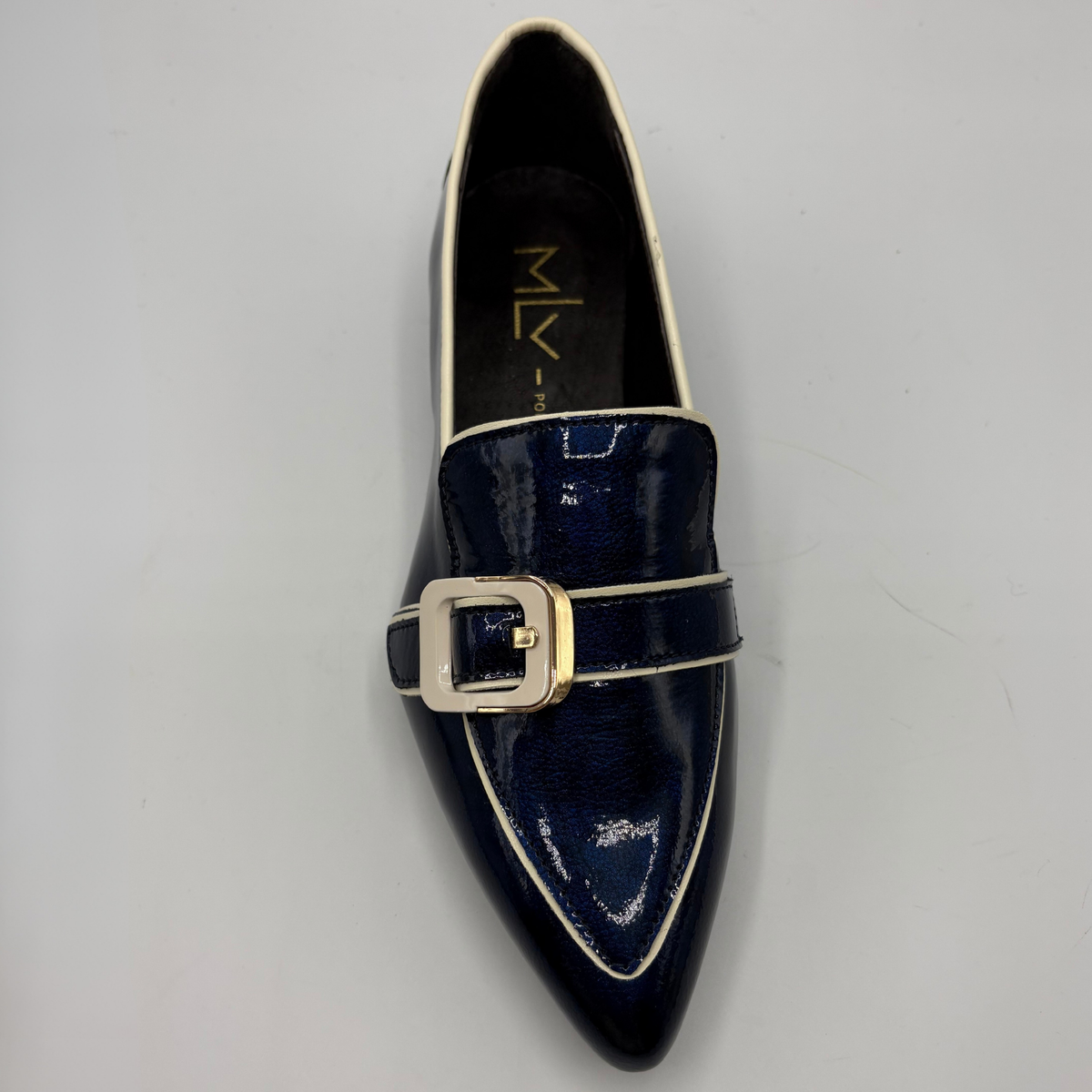 Top view of a dark blue patent leather loafer with a pointed toe and a buckle strap accent