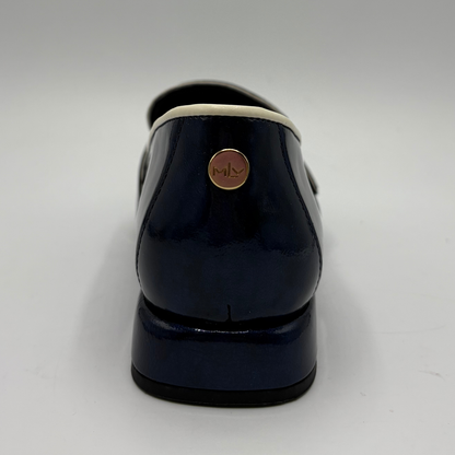 Back view of a dark blue patent leather loafer with a pointed toe and a buckle strap accent