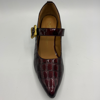 Top view of a burgundy high heeled shoe with a flared heel and gold buckle