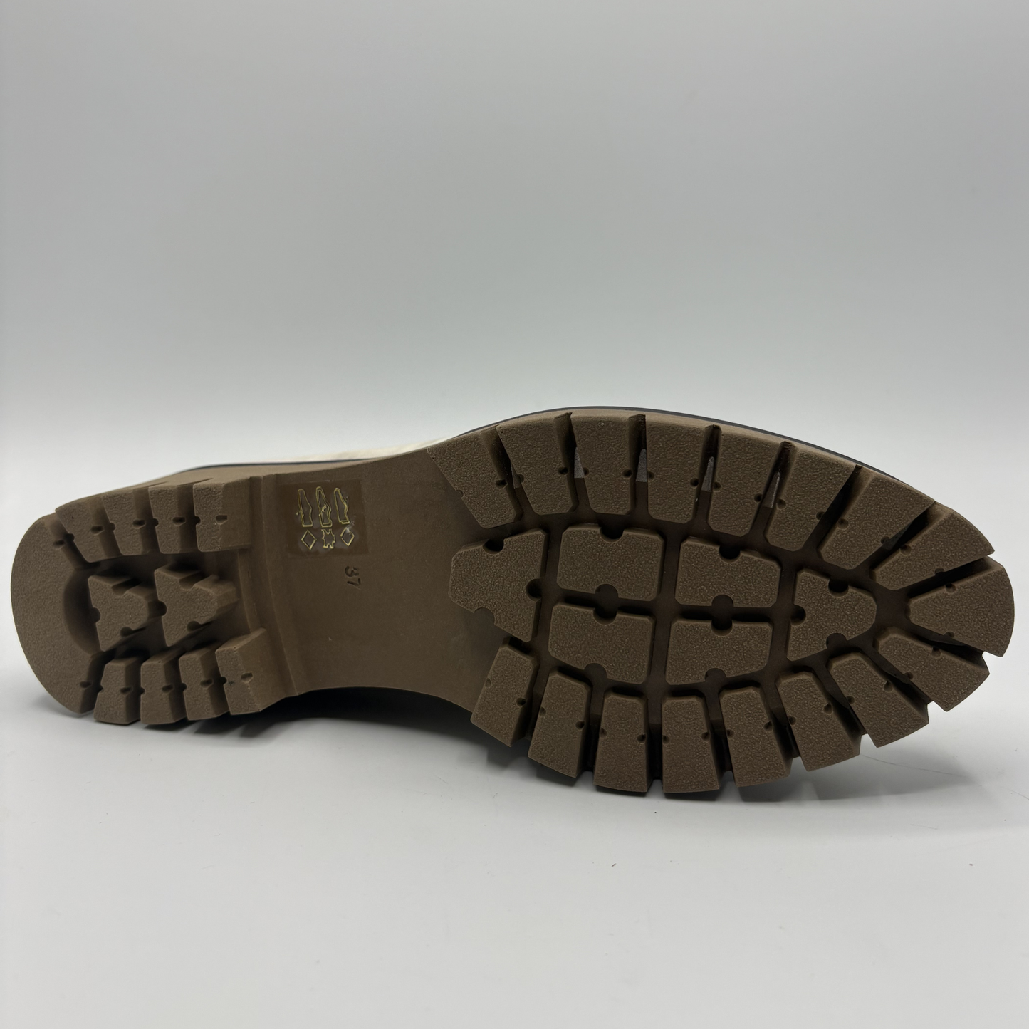 Bottom view of a metallic leather loafer with a rubber outsol