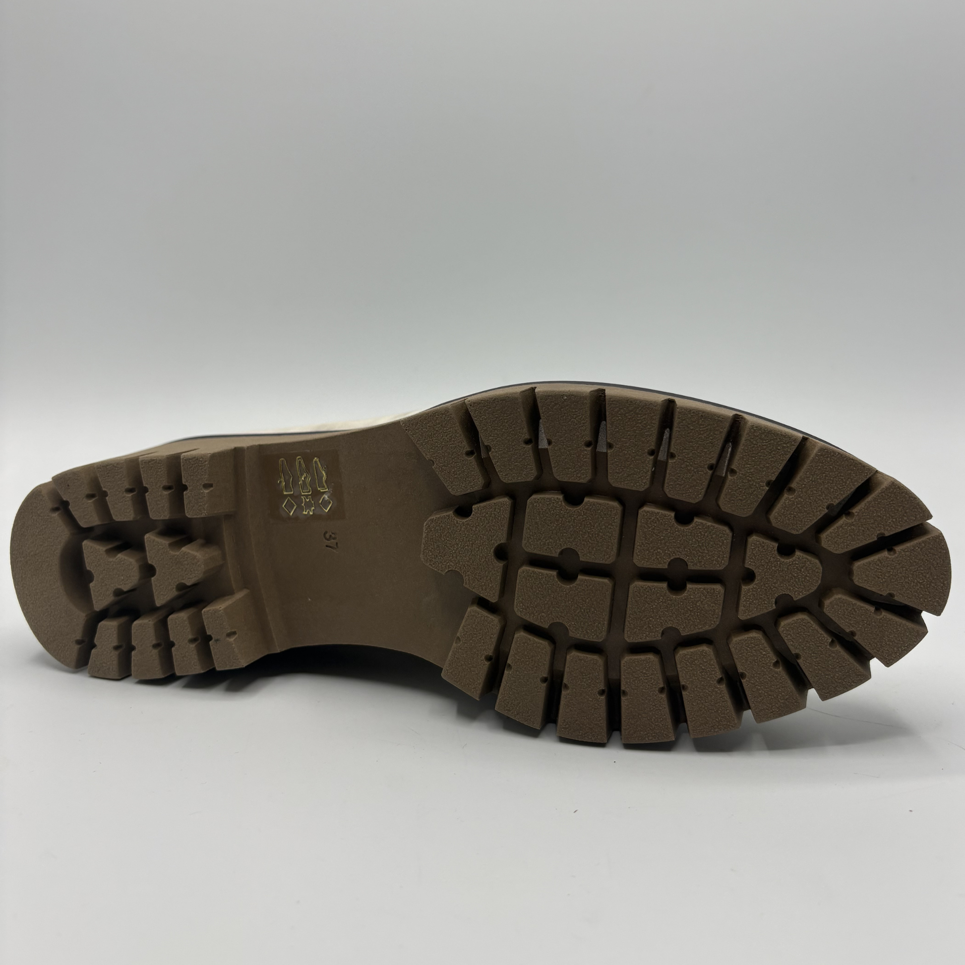 Bottom view of a metallic leather loafer with a rubber outsol