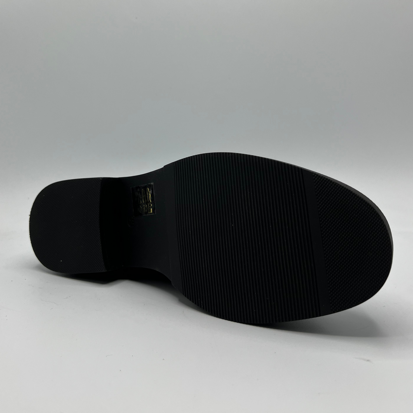 Black shoe sole on a gray background