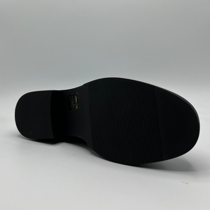 Black shoe sole on a gray background
