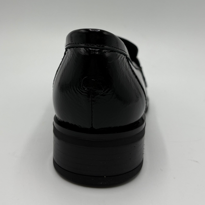 Back view of a black leather loafer with an animal print accent on the toe box and chain detail.