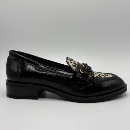 Right facing view of a black leather loafer with an animal print accent on the toe box and chain detail.