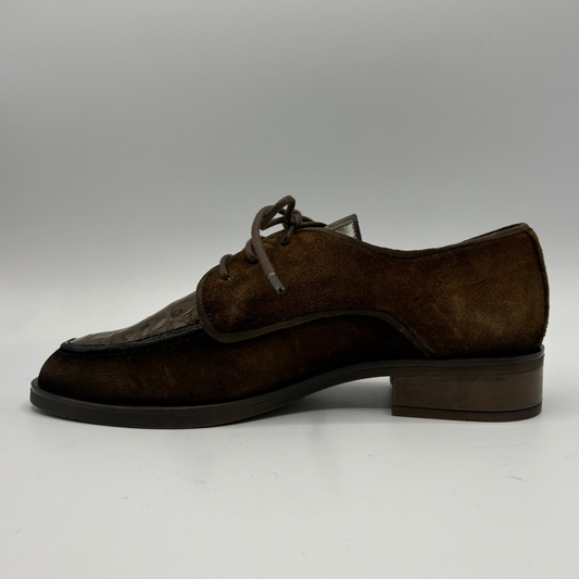 Left facing view of a brown oxford shoe with a short stacked heel and matching laces