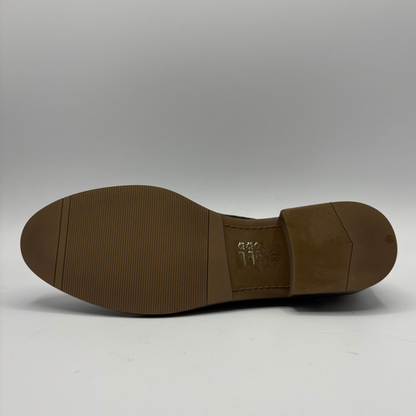 Bottom view of a brown oxford shoe with a short stacked heel and matching laces