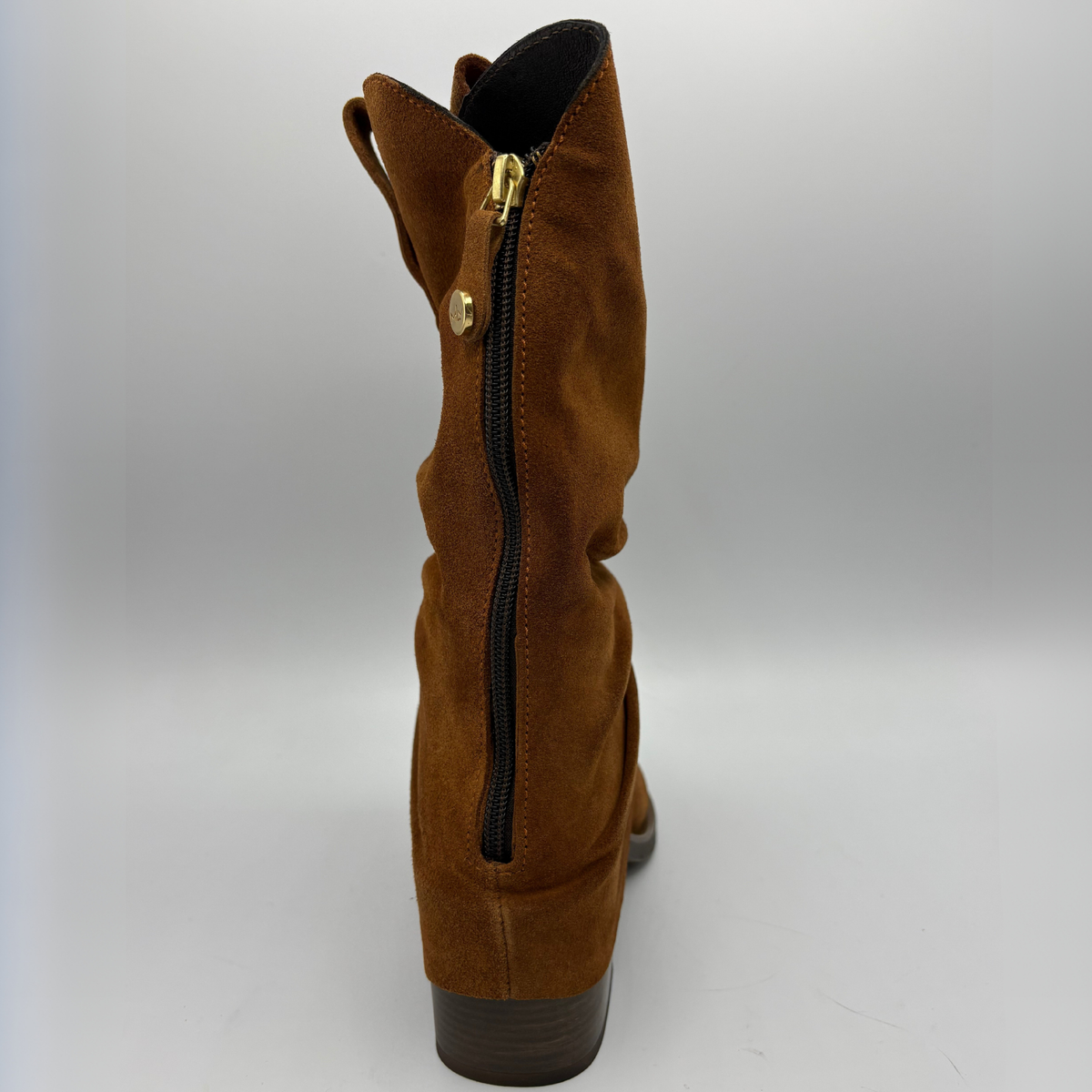 Back facing view of a brown suede western style slouchy boot