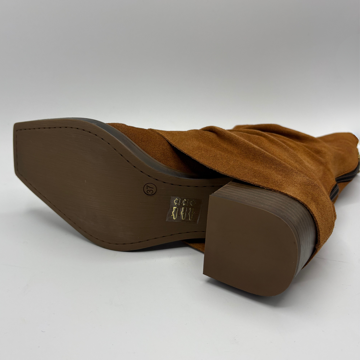 Bottom facing view of a brown suede western style slouchy boot