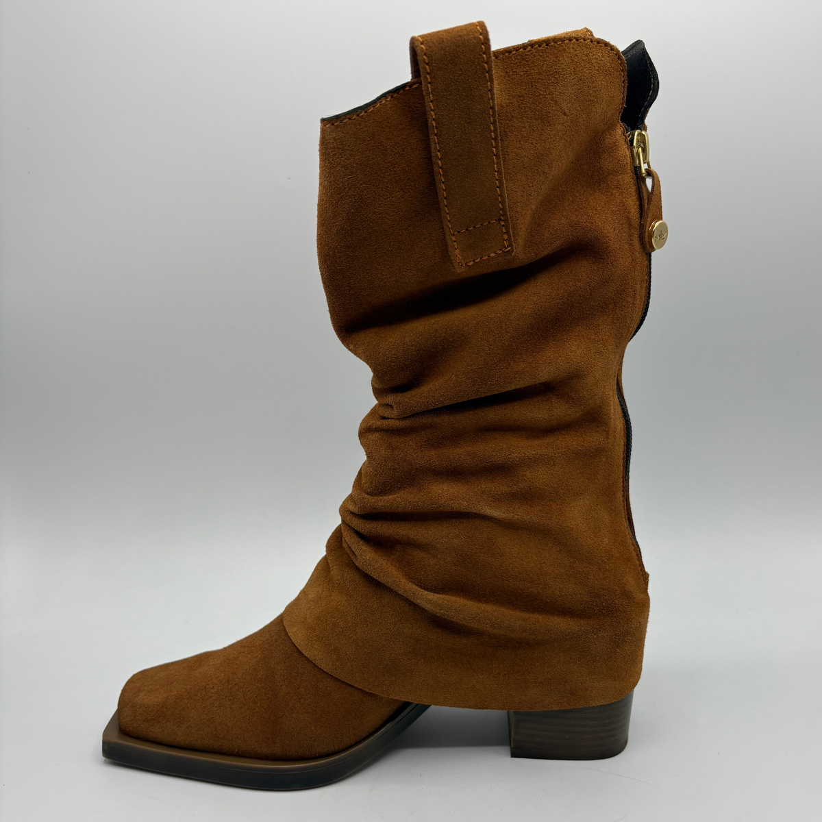 Left facing view of a brown suede western style slouchy boot