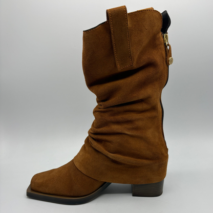 Left facing view of a brown suede western style slouchy boot