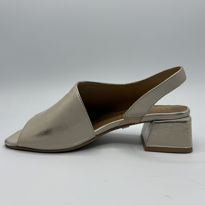 Shiny beige sandal with block heel on a gray background