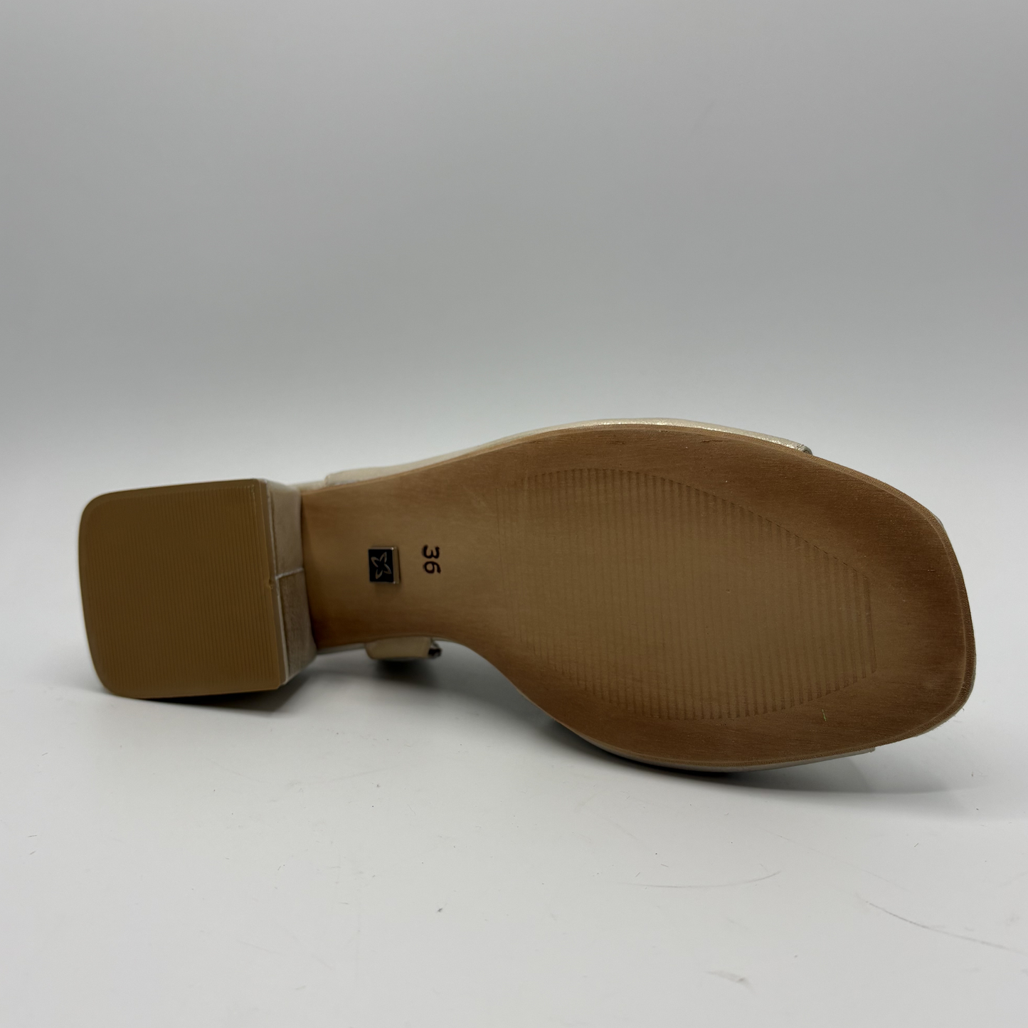 Shiny beige sandal with block heel on a gray background