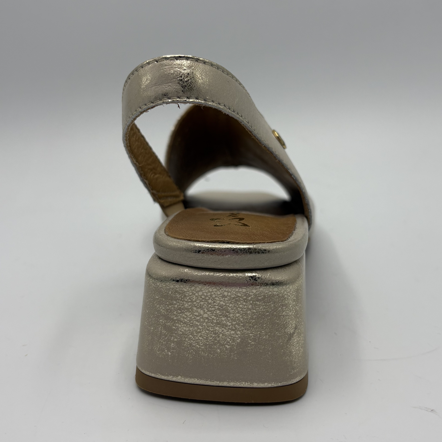 Shiny beige sandal with block heel on a gray background