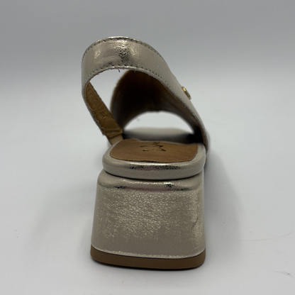 Shiny beige sandal with block heel on a gray background