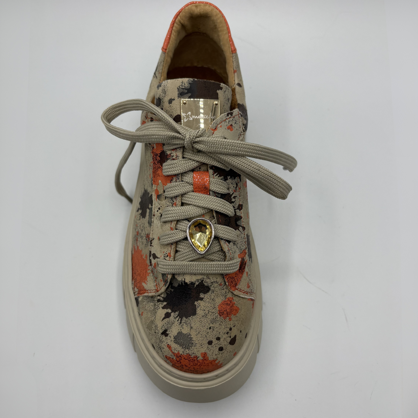 Sneaker with a charm on a white background