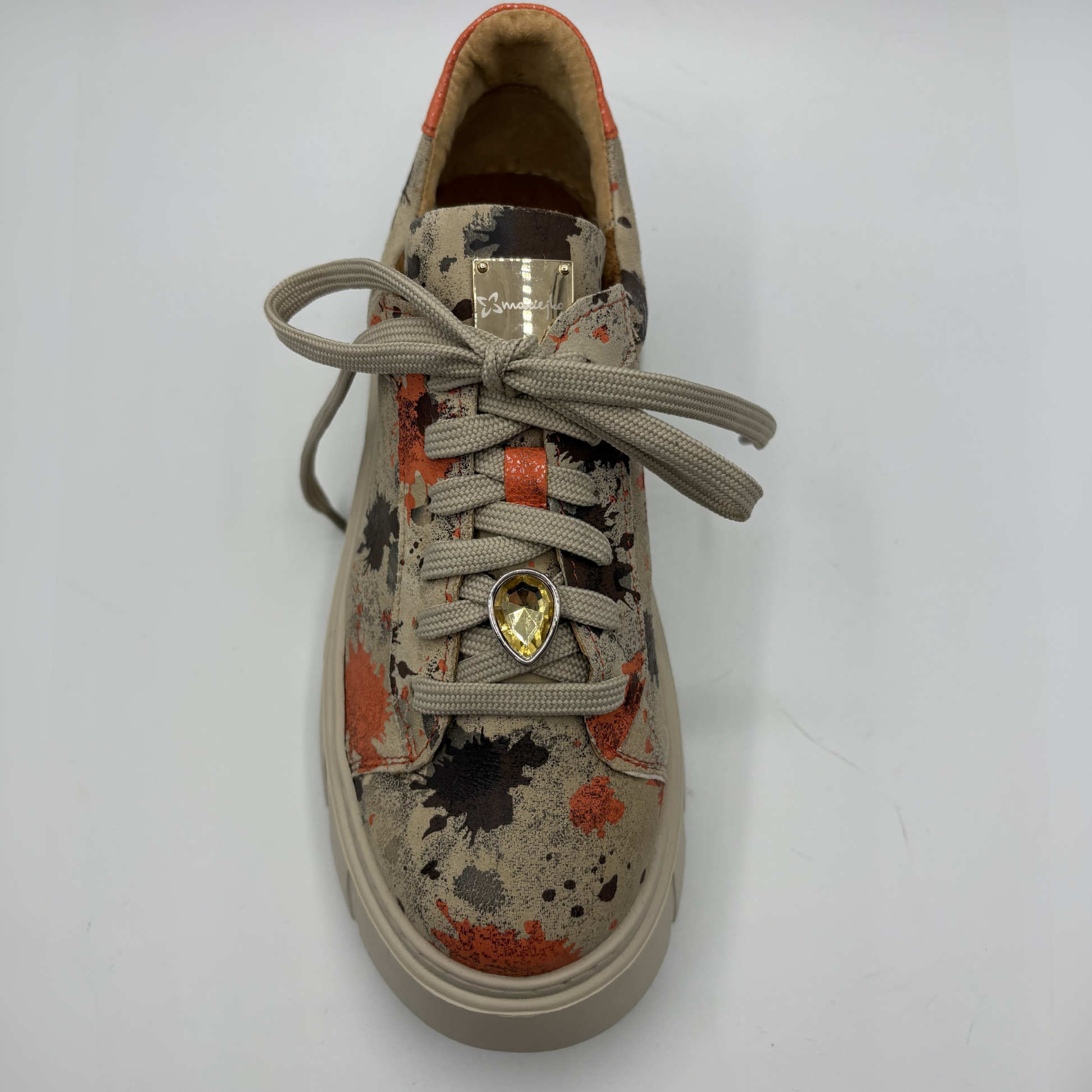 Sneaker with a charm on a white background