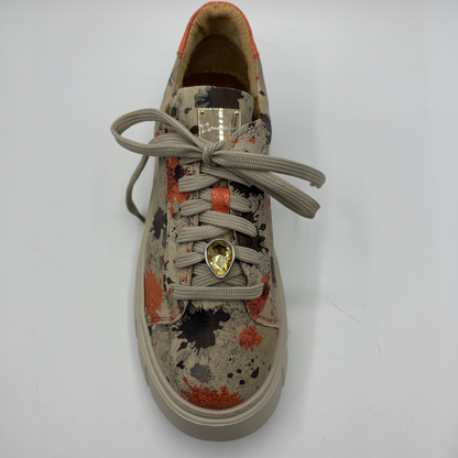 Sneaker with a charm on a white background