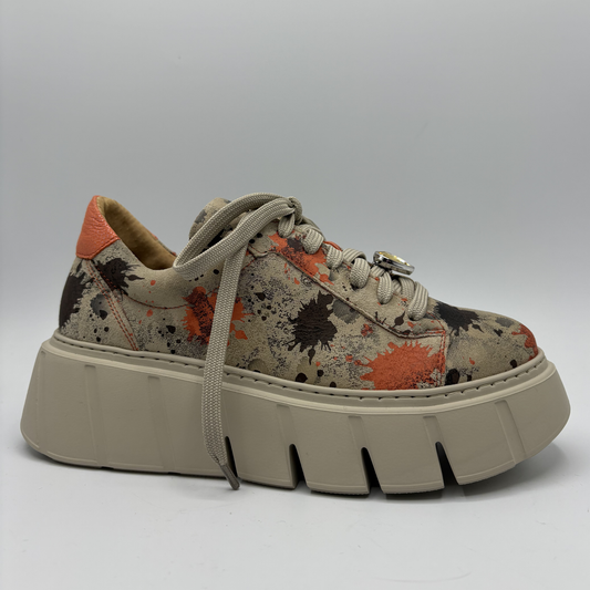 Platform sneaker with splatter pattern on a gray background