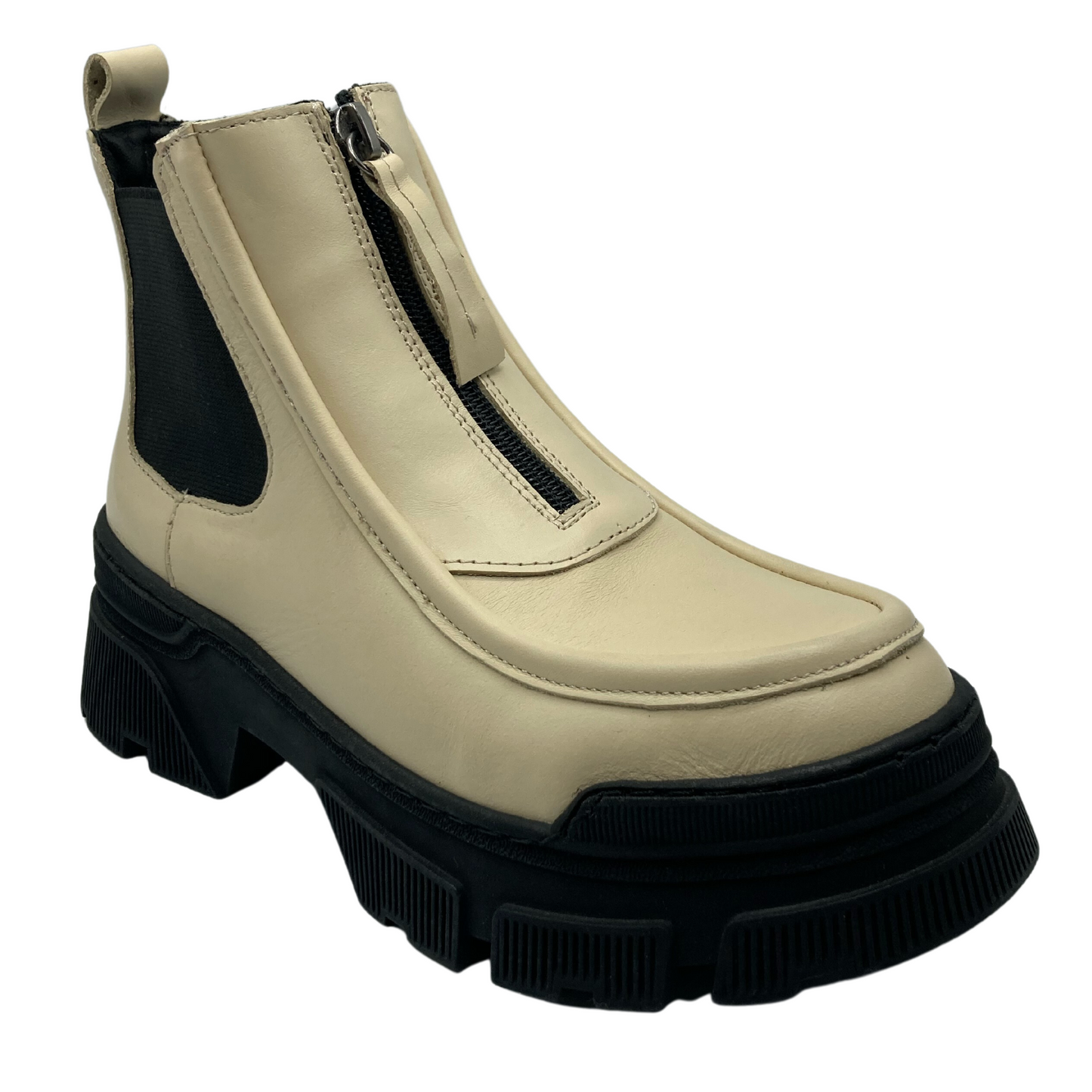 45 degree angled view of beige leather ankle boot with black zipper and black rubber outsole