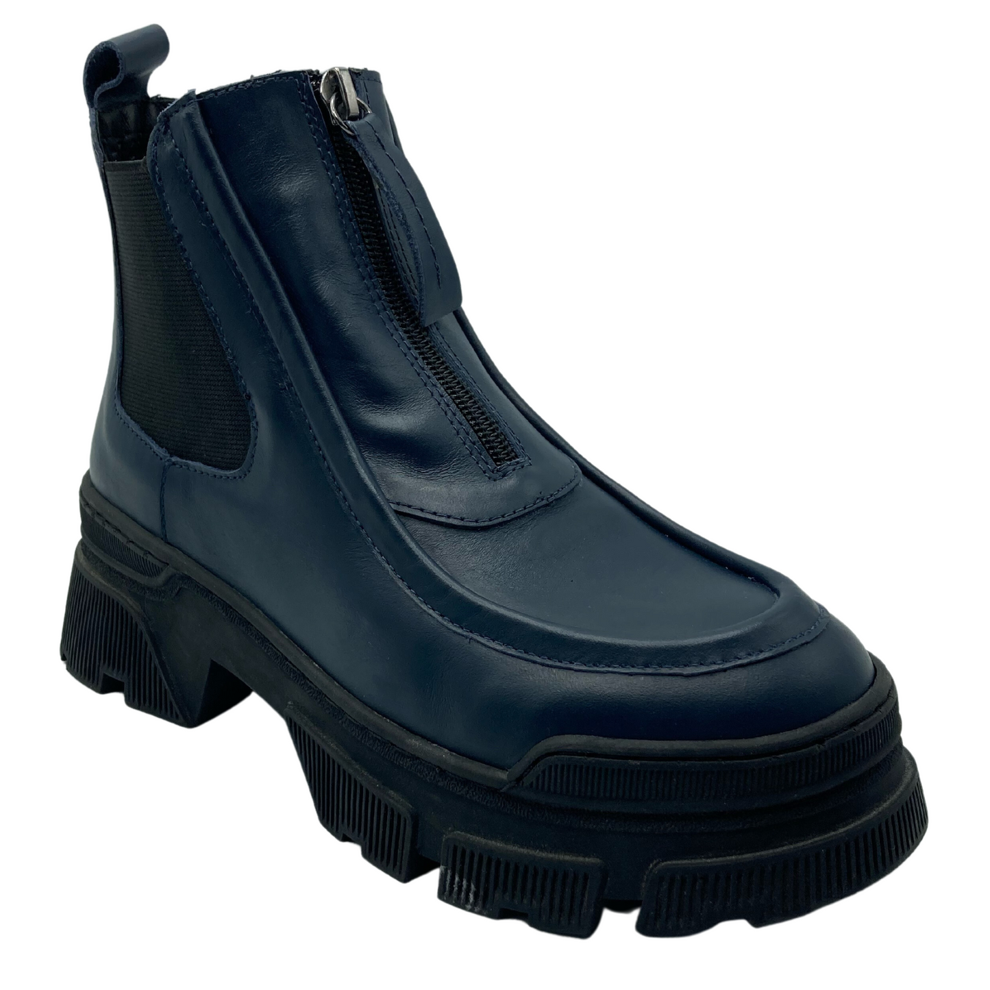 45 degree angled view of navy leather short boot with lug black rubber sole, elastic side gore and upper zipper