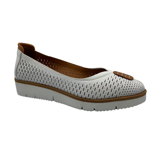 45 degree angled view of white perforated leather flat with thick outsole and leather lining