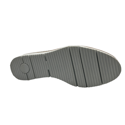 Bottom view of white perforated leather flat with thick outsole and leather lining