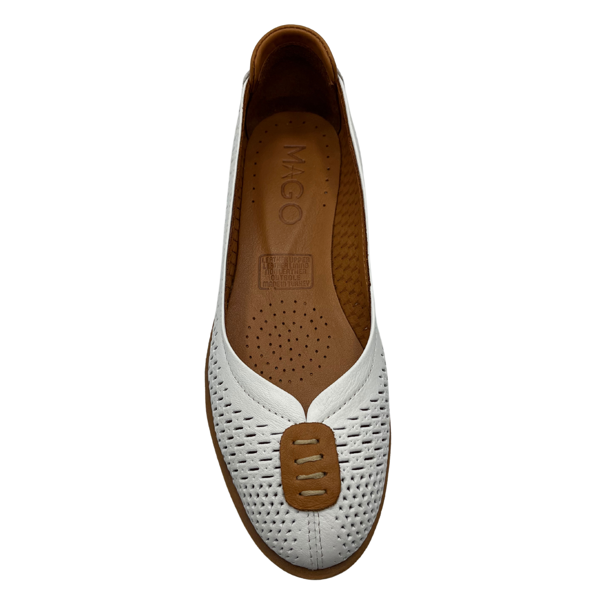 Top view of white perforated leather flat with thick outsole and leather lining