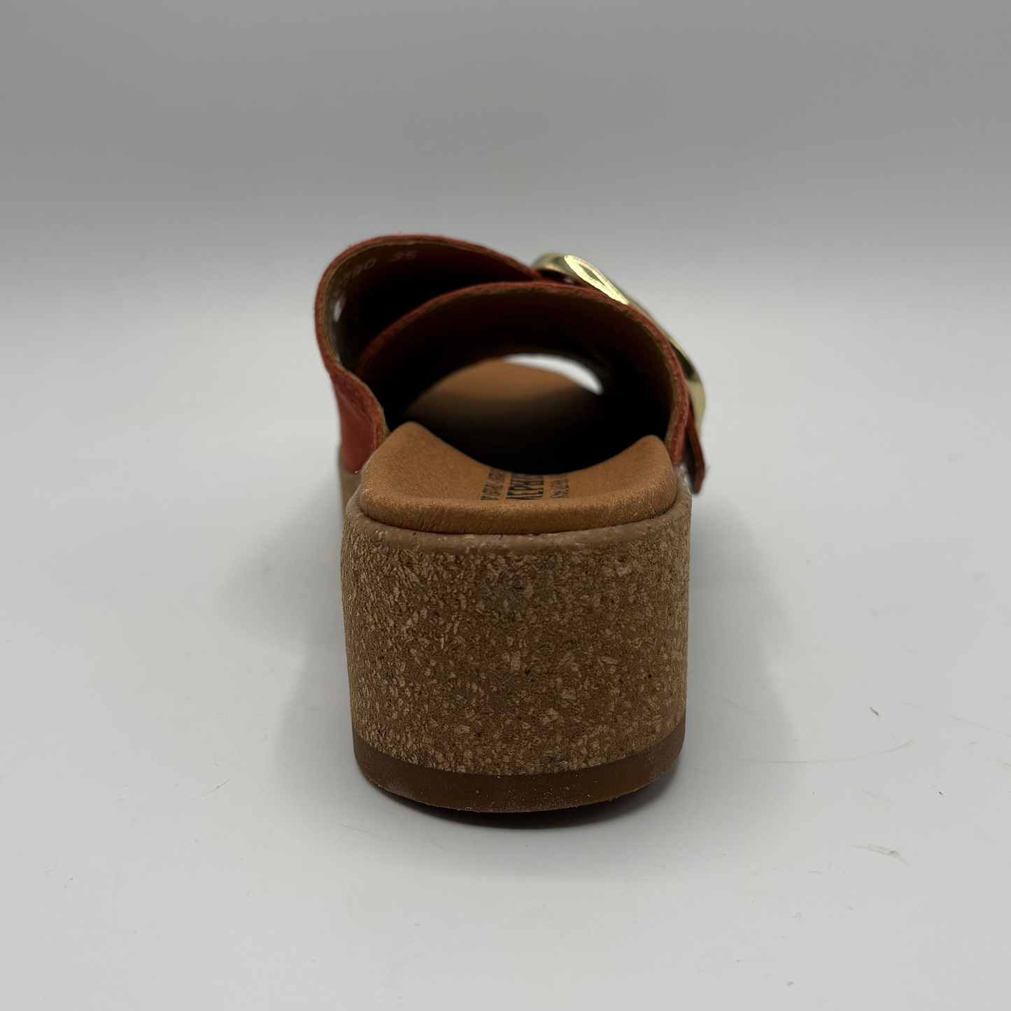 Brown sandal with cork sole on a white background