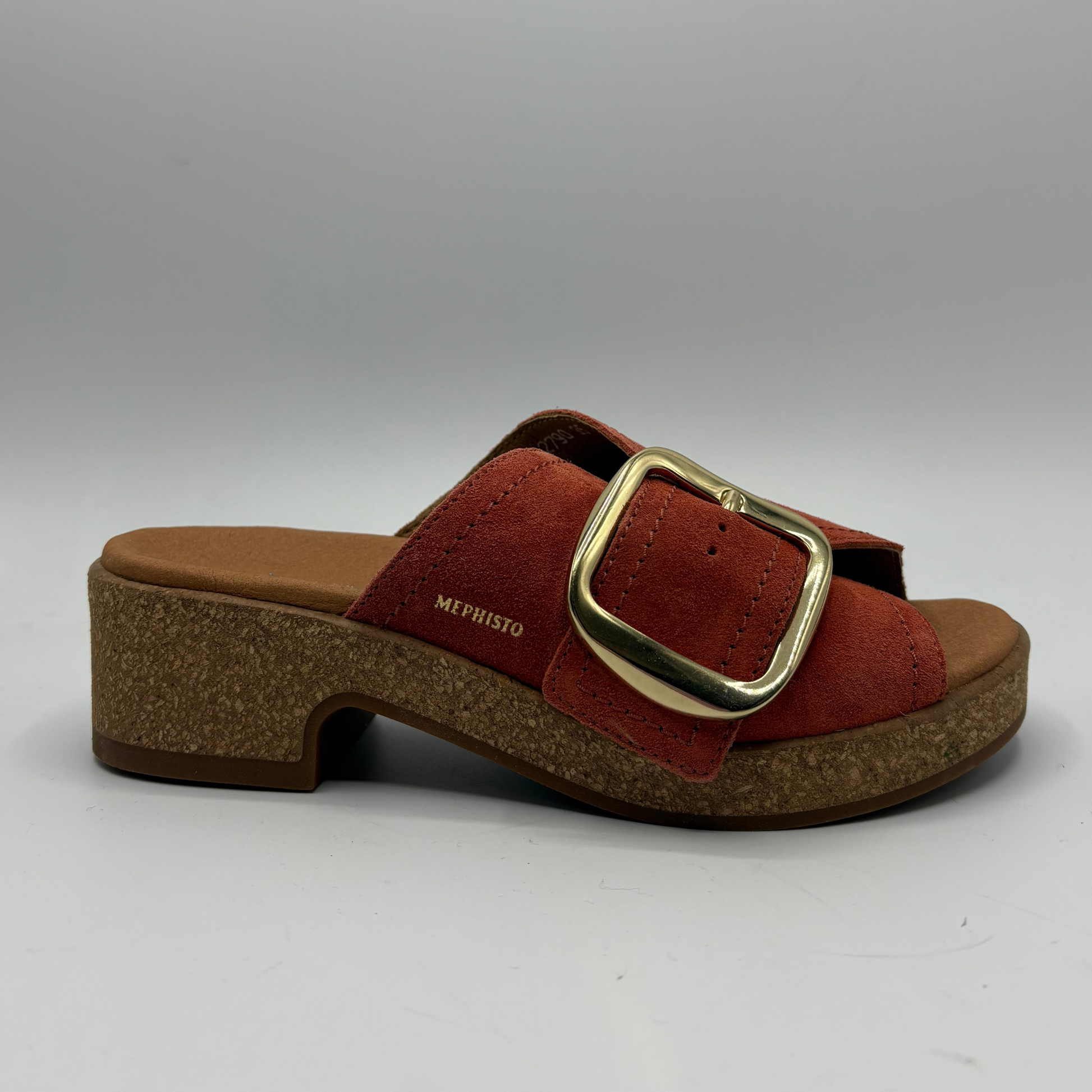 Brown sandal with gold buckle on a white background