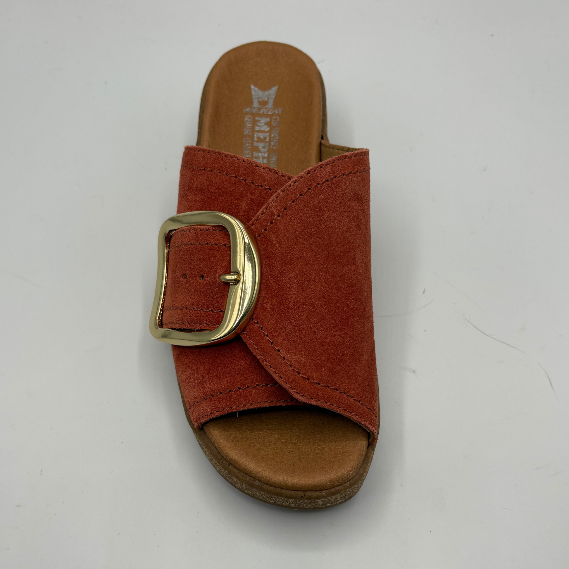 Brown sandal with a gold buckle on a white background