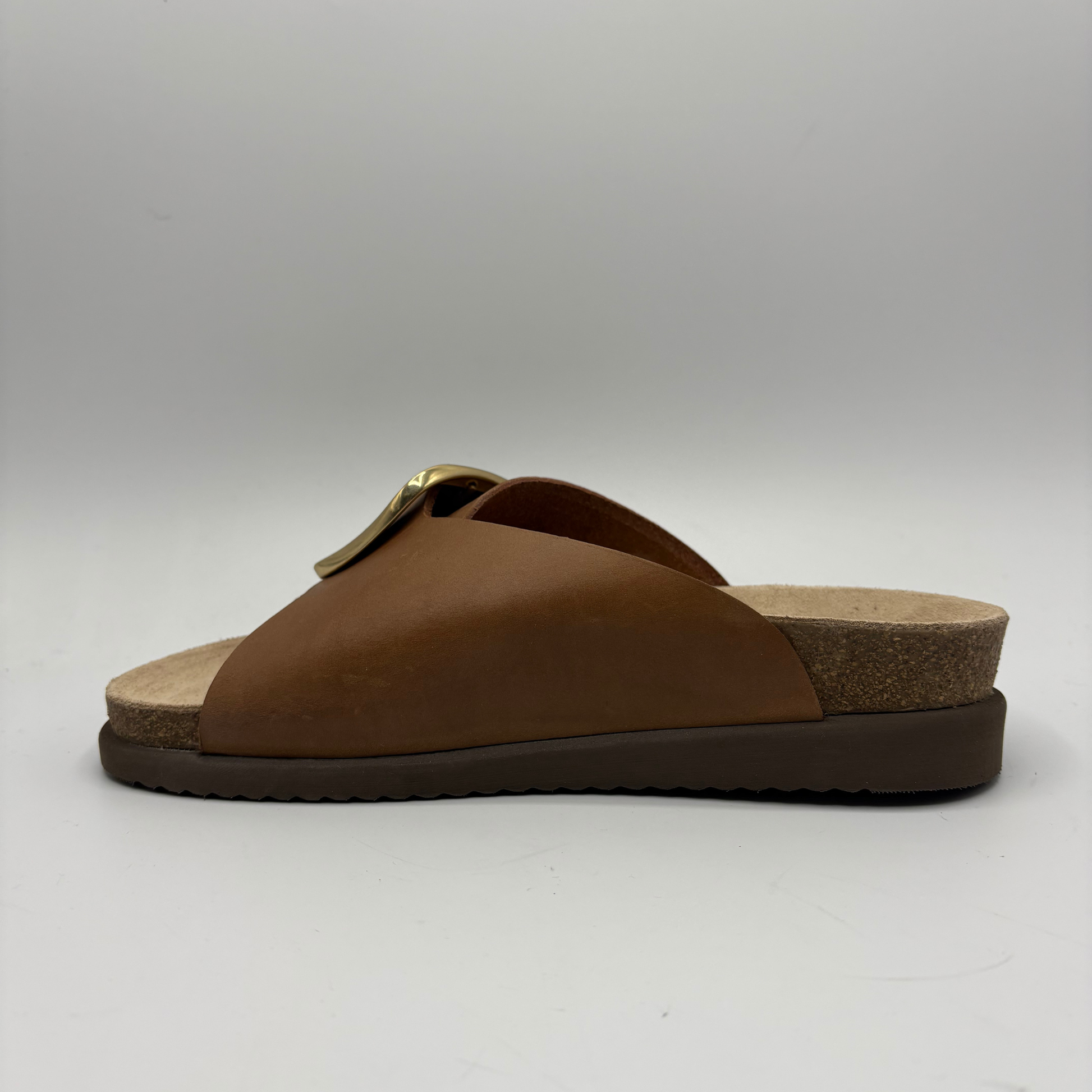 Brown sandal with a cork sole on a white background