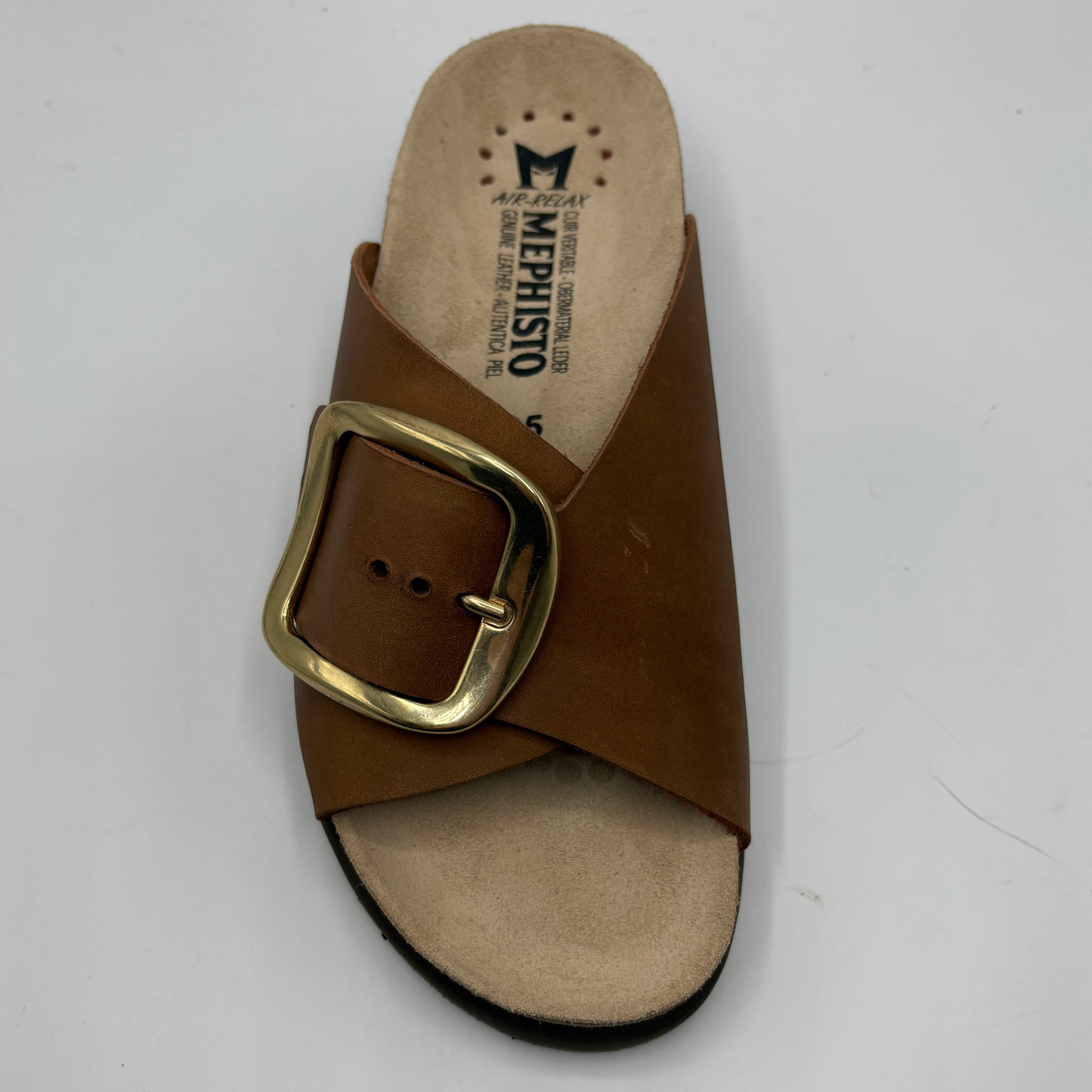 Brown sandal with gold buckle on a white background