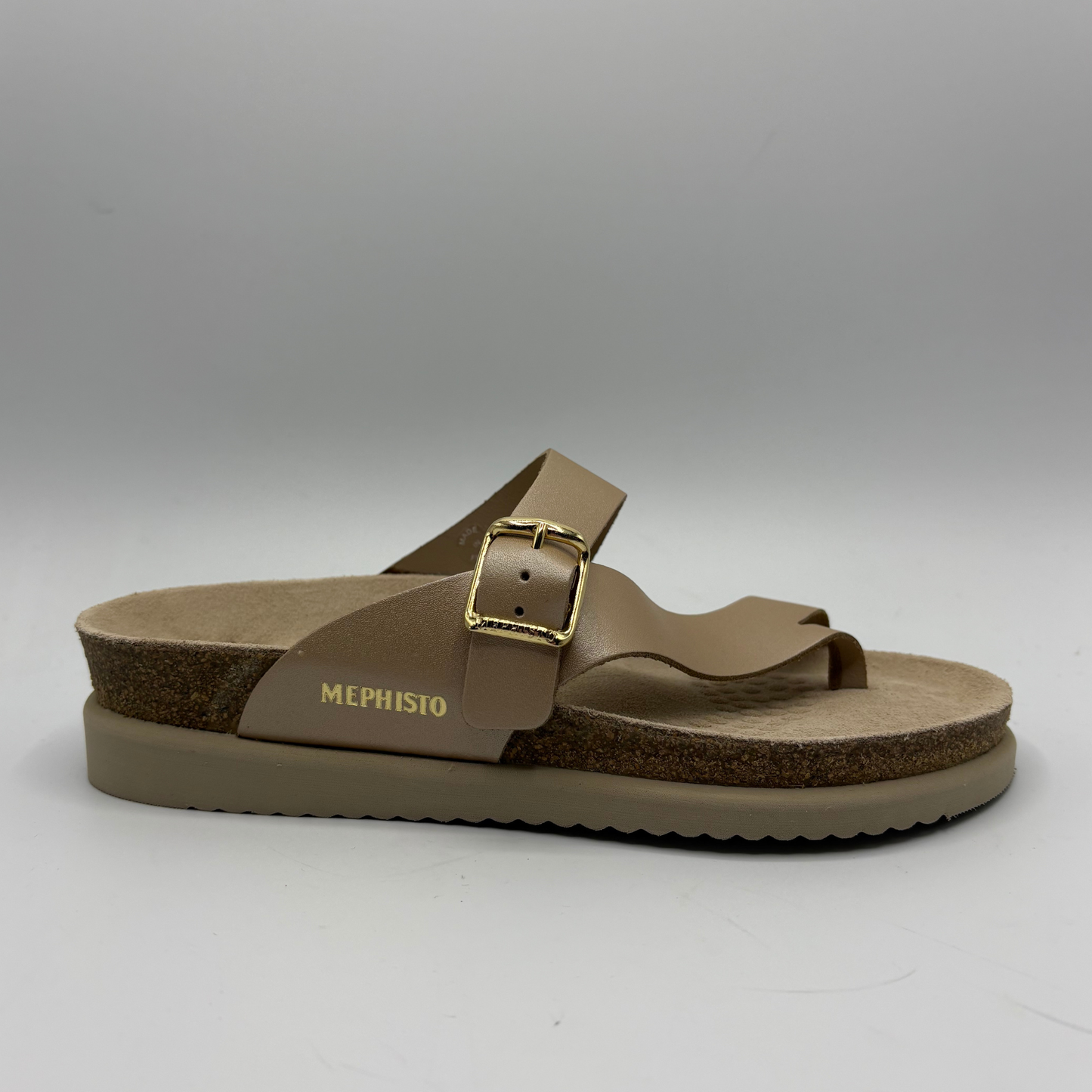 Brown sandal with a gold buckle on a gray background