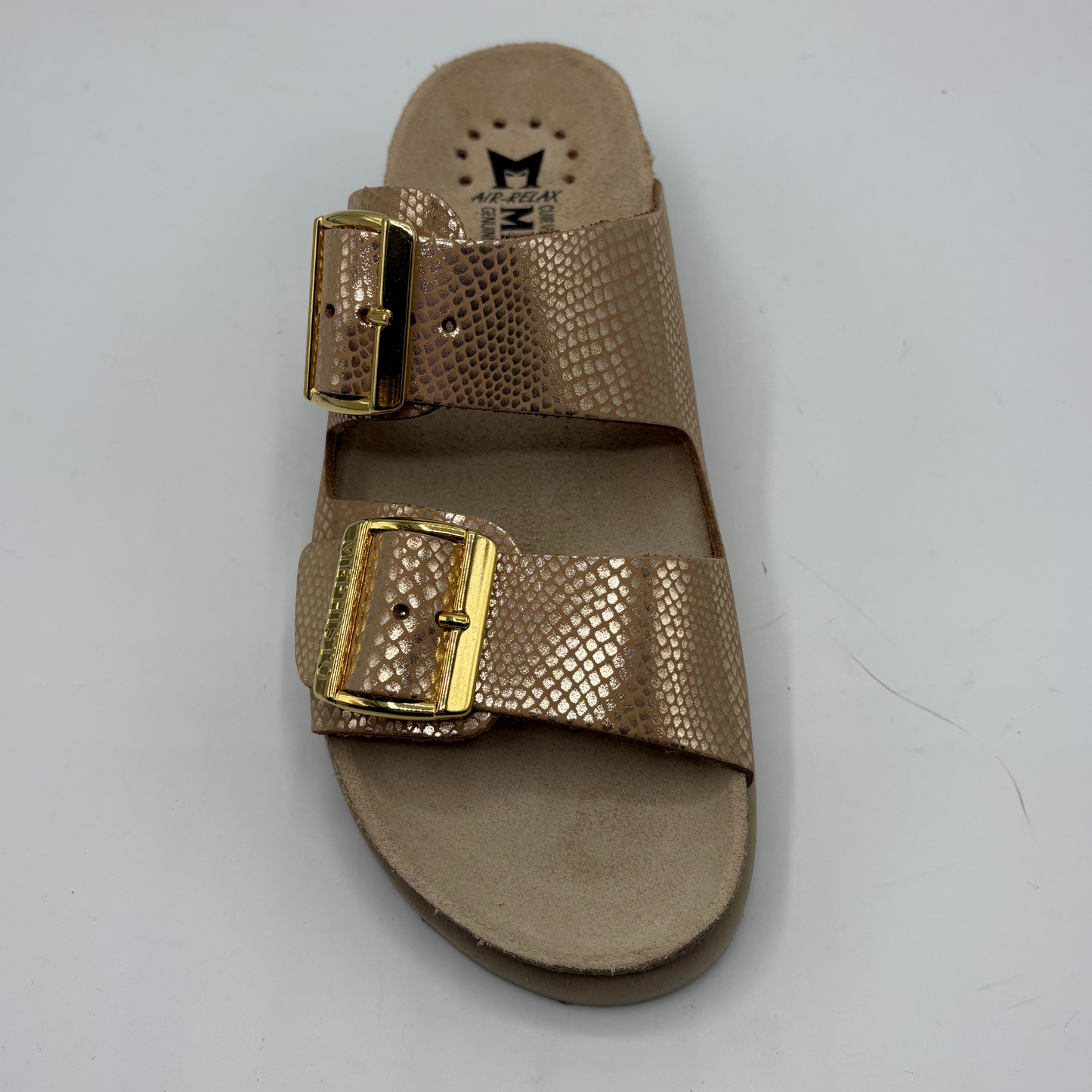 Gold sandal with a gold buckle on a gray background