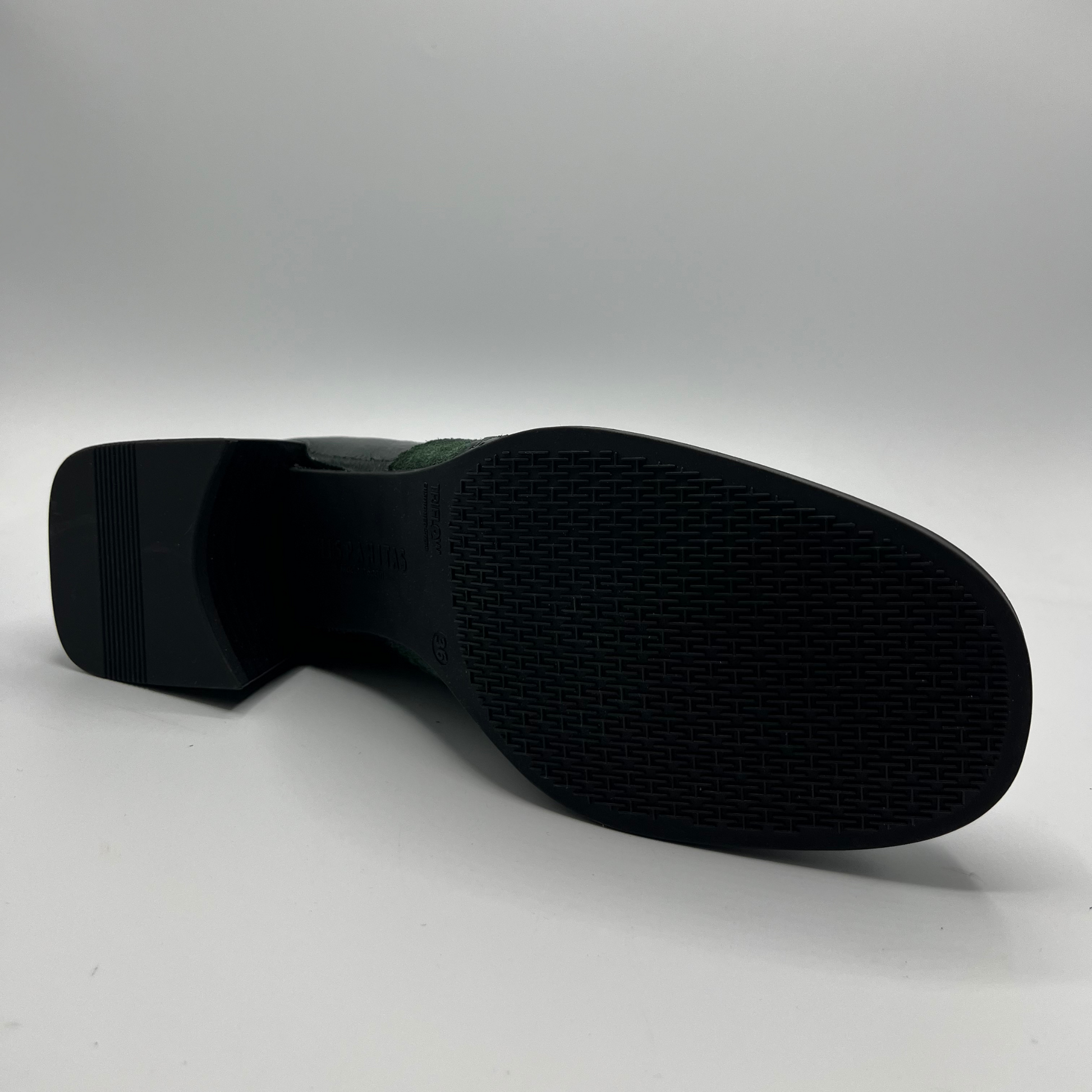 Black shoe sole on a light gray background