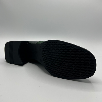 Black shoe sole on a light gray background