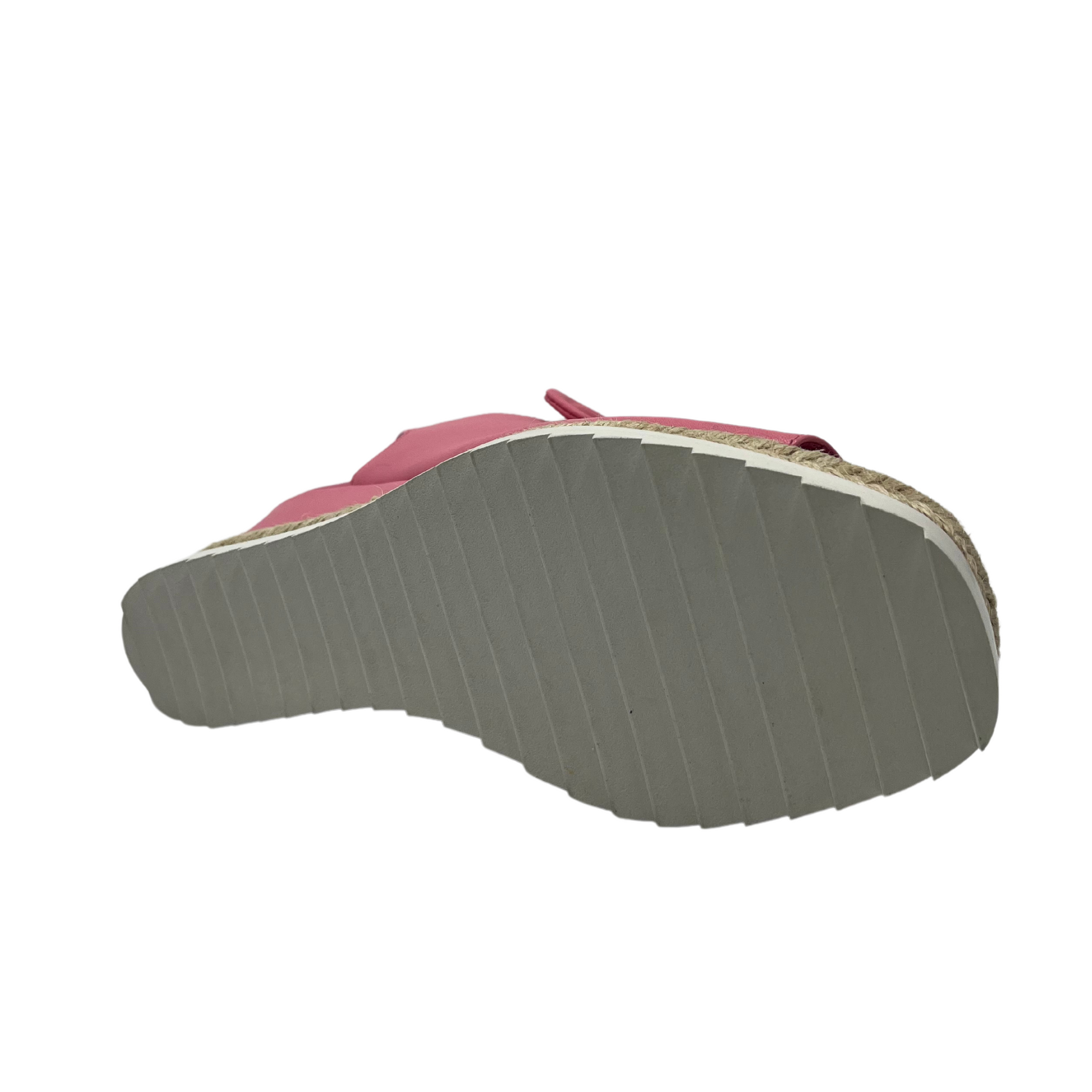 Bottom view of pink leather wedge sandal with slingback strap and bow detail
