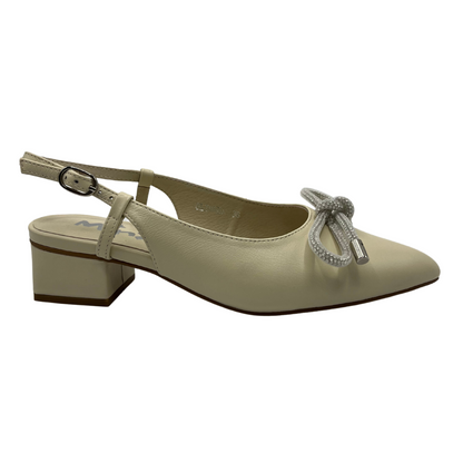 Right facing view of an ivory leather slingback pump with a rhinestone bow detail on upper and pointed toe.