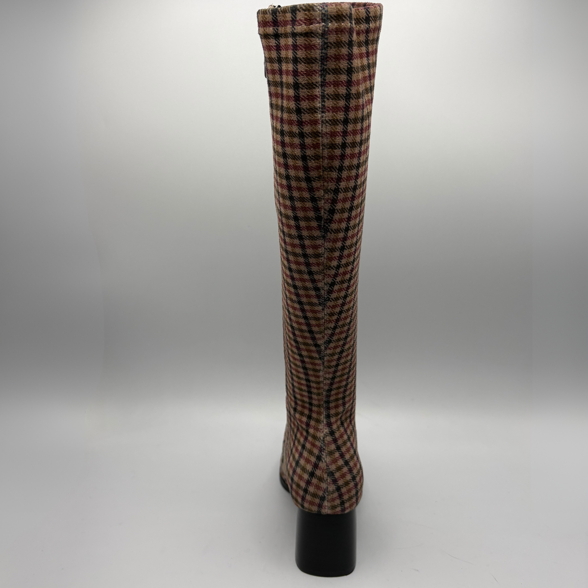A knee-high pointed-toe boot with a black block heel, featuring a red, black, and white plaid pattern on a clean white background.