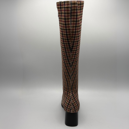 A knee-high pointed-toe boot with a black block heel, featuring a red, black, and white plaid pattern on a clean white background.