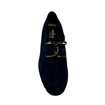 Top view of navy suede loafer with thick rubber outsole and gold/black detail on upper