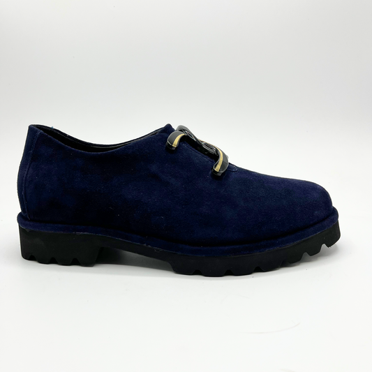 Right facing view of navy suede loafer with thick rubber outsole and gold/black detail on upper
