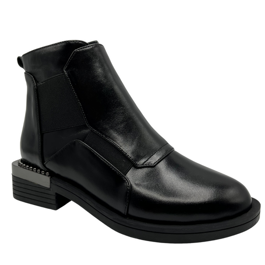 45 degree angled view of black leather short boot with elastic panels for easy on and off. Short chunky heel with decorative studs and rounded toe.