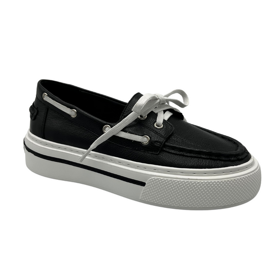 45 degree angled view of a black leather boat shoe with white rubber platform outsole and white laces