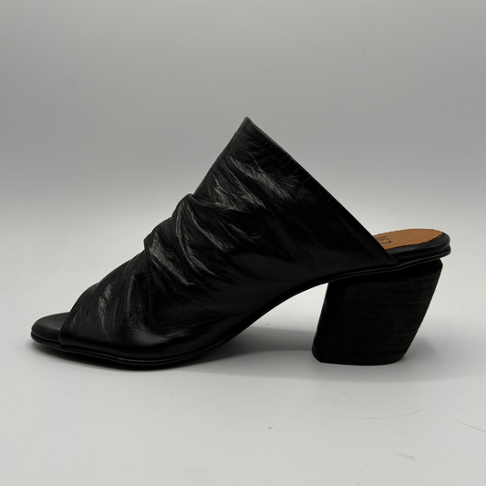 Left facing view of a slouchy black leather sandal with a 2 inch heel